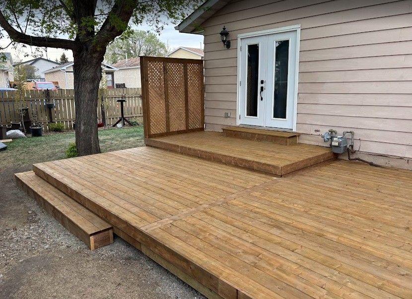 Newly built wooden deck with a small raised step near the door.