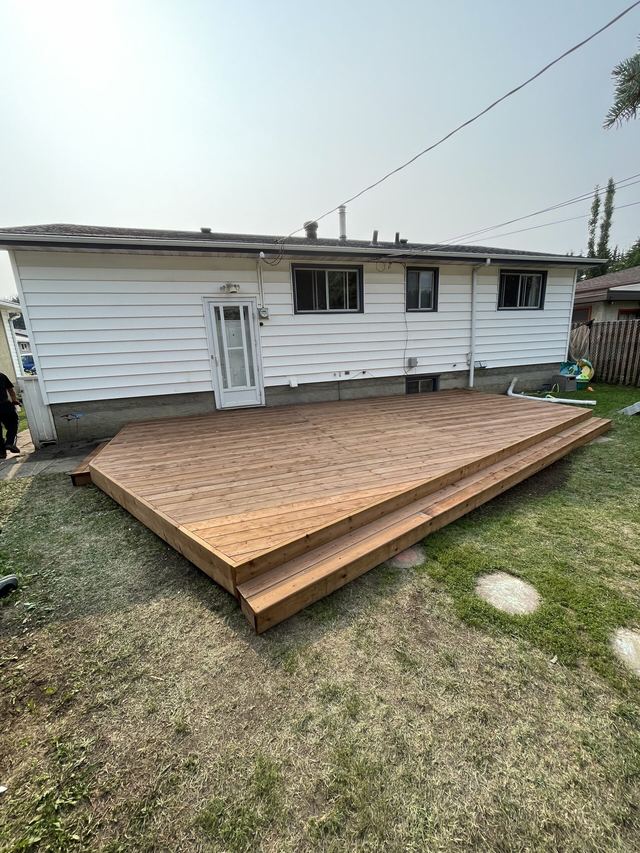 Newly built wooden deck next to a house.