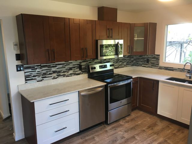 Modern kitchen with wooden cabinets and stainless steel appliances.