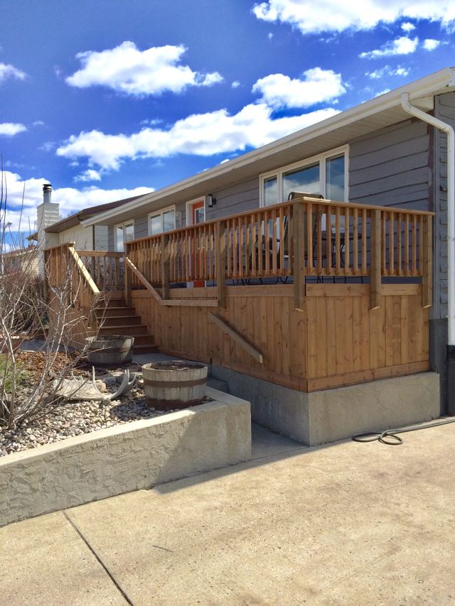 New wooden deck and stairs added to the house exterior.