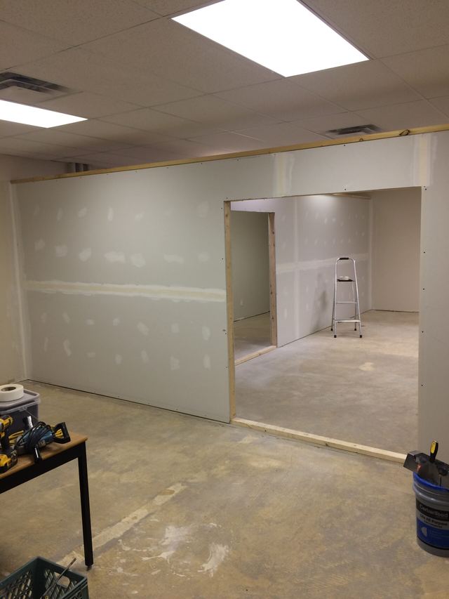 Unfinished drywall in a basement under renovation.
